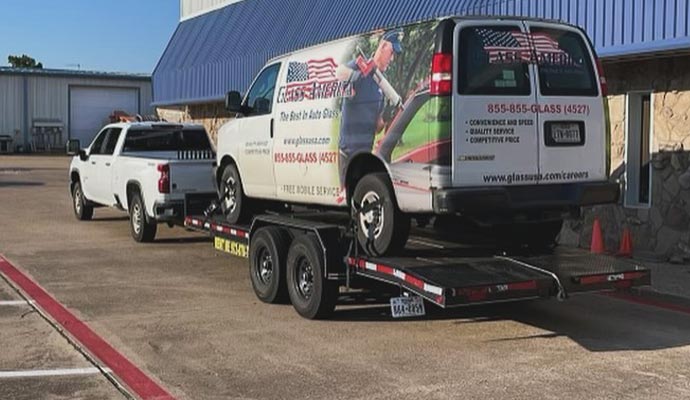 Business van hauling service with trailer and pickup truck Pickup truck towing a trailer with a business service van loaded on it